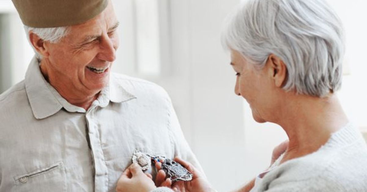 Senior Vet and woman admiring medals